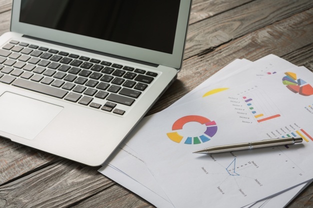 laptop-with-colorful-business-documents_1232-821